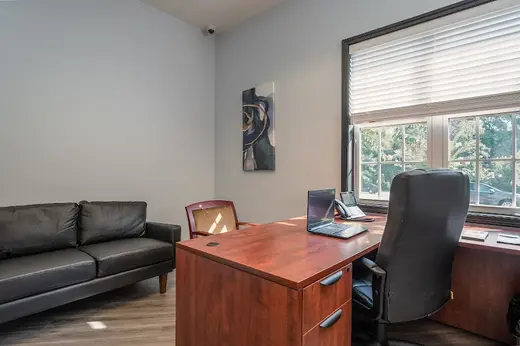 Bright office space with desk and couch at Recover Now Greater Atlanta, a detox center in Atlanta.
