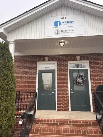 Brick exterior with green doors at Restoration Outpatient Detox Woodstock, a detox center in Atlanta.