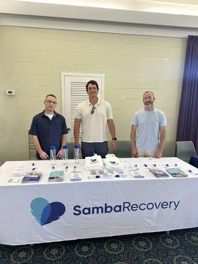 Informative display table at a community event for a partial hospitalization program in Atlanta.