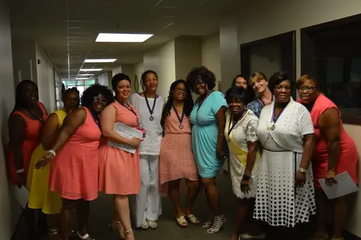 Group of women celebrating at Mary Hall Freedom Village, a sober living home in Atlanta.