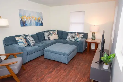 Cozy living room with sectional sofa at Creekside Recovery Residences, a sober living home in Atlanta.