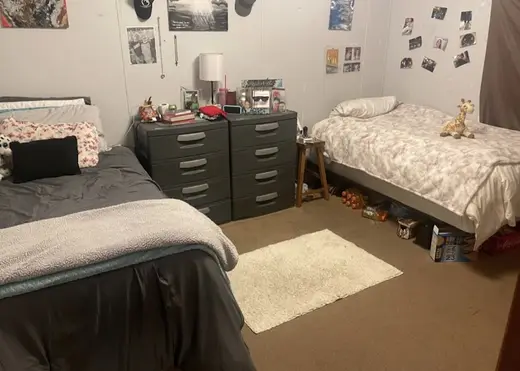 Cozy shared bedroom with two beds at New Beginnings Recovery Homes for Women, a sober living home in Atlanta.