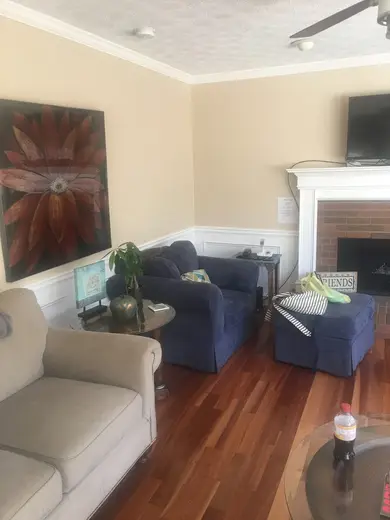 Cozy living room with blue chairs at Sober Men Living, a sober living home in Atlanta.
