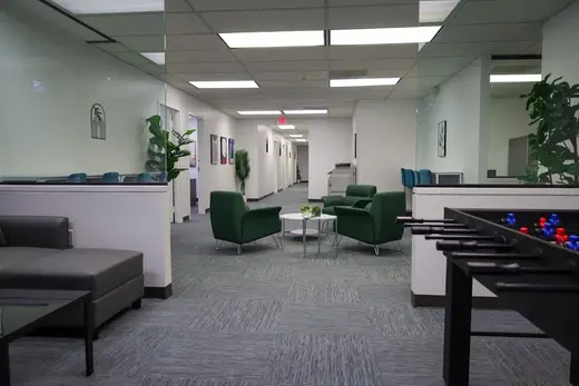 Bright waiting area with green chairs at Resilience Behavioral Health: Menta, a treatment center in Atlanta.
