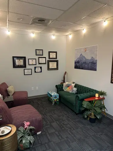 Cozy waiting area with green sofa at Atlas Behavioral Health: Addiction Treatment Center in Atlanta.