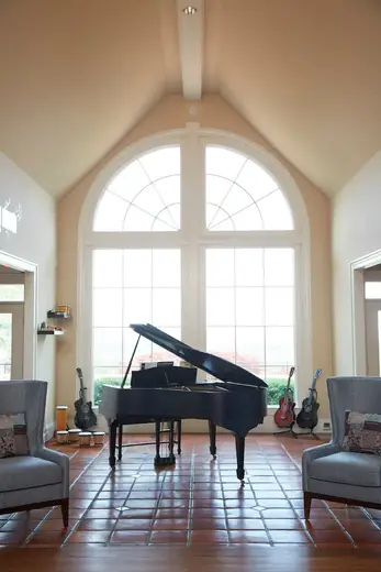 Elegant grand piano in sunlit common area at Bluff Augusta Alcohol & Drug Rehab treatment center in Atlanta.
